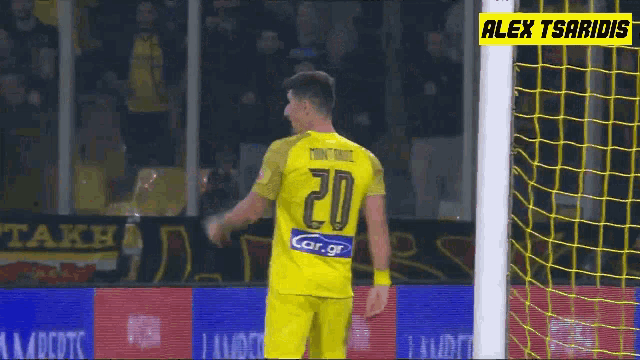 a soccer player wearing a yellow jersey with the number 20