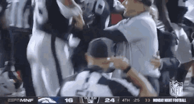 a referee is surrounded by players during a football game