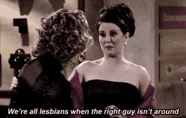 two women are standing next to each other in a room and one of them is talking about being lesbians .