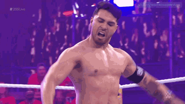 a shirtless wrestler is standing in a wrestling ring with the hashtag # 206live