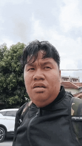 a man wearing a black jacket and a backpack that says ' supreme ' on it