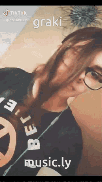 a girl is wearing glasses and a black shirt that says grace universe on it