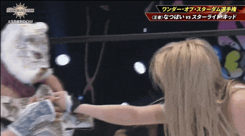 a woman in a mask is fighting another woman in a ring with the words stardom on the bottom