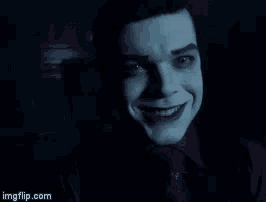 a close up of a man 's face with a joker smile on it