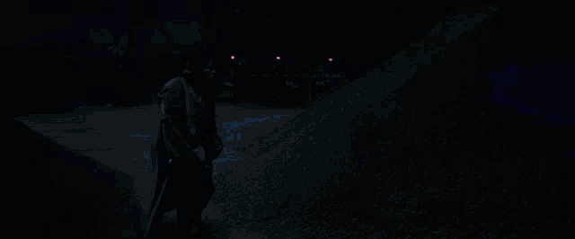 a man is holding a blue lightsaber in his hand
