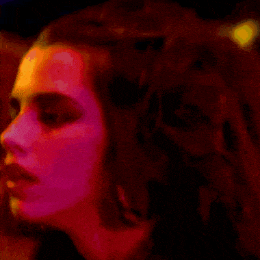 a close up of a woman 's face with a purple background