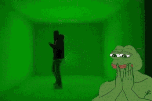 a green frog is standing next to a group of people walking down stairs in a dark room .