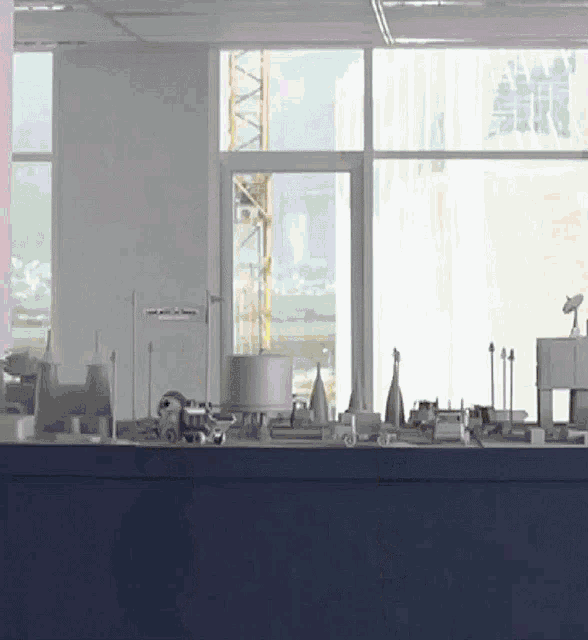 a room with a lot of objects on a table and a sign that says ' no smoking '