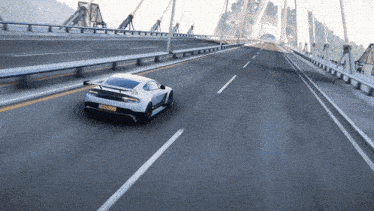 a white sports car is driving on a bridge with a license plate that says aa - nz - nb