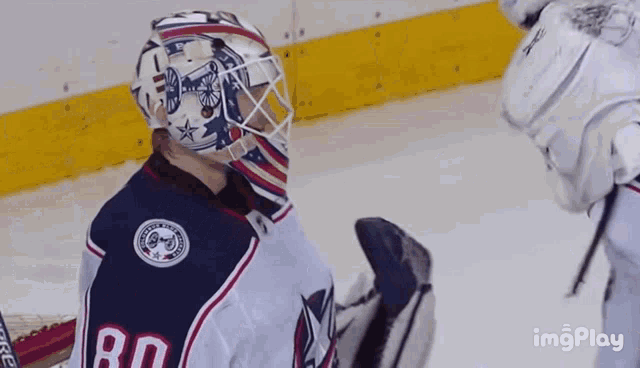 a hockey goalie with the number 80 on his back