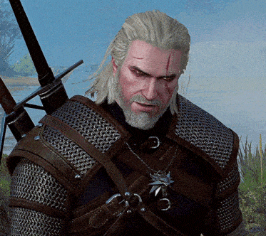 a man with a beard wearing chain mail and a star pendant