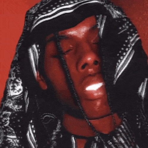 a close up of a person 's face with a hood on
