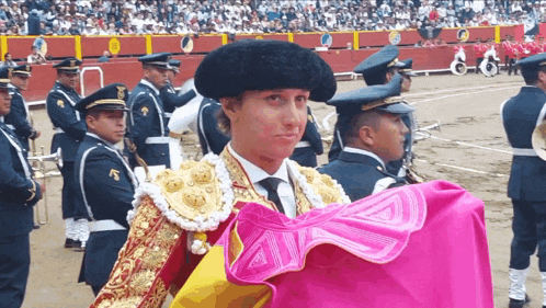 a man in a military uniform holds a pink cloth