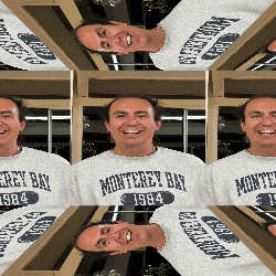 a man wearing a monterey bay 1984 sweatshirt smiles