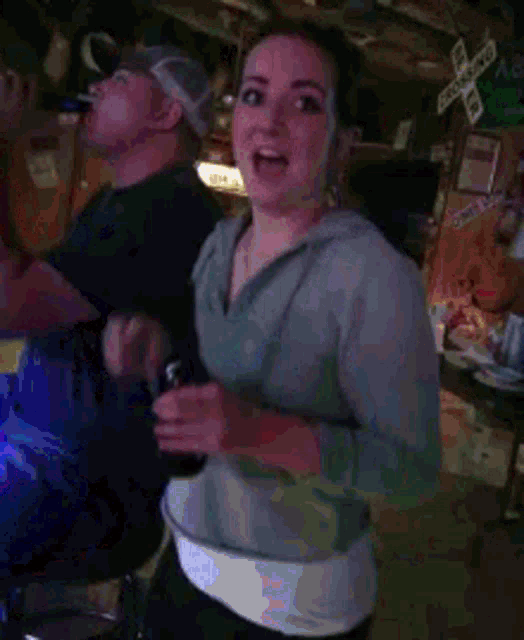 a man and a woman in a bar with a sign that says railroad crossing in the background