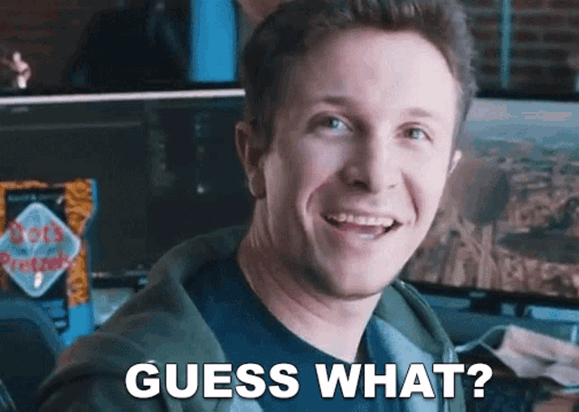 a man is smiling and says " guess what "