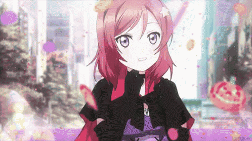 a girl with red hair is wearing a black cape