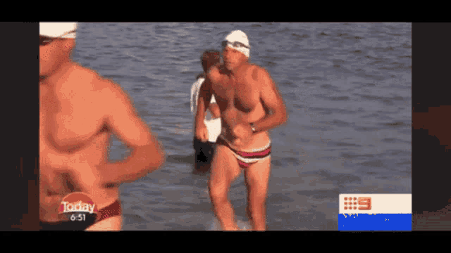 a man in a swim cap is running in the water while a news report says today 5:53