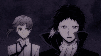 a couple of anime characters are standing next to each other in a dark room .