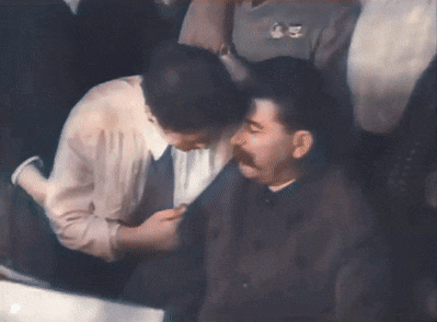 a man with a mustache is being touched by a woman
