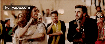 a man and a woman are dancing together in front of a crowd .