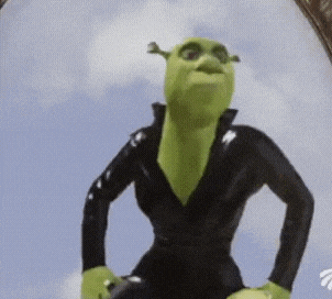 shrek from the movie shrek is wearing a black suit and standing with his hands on his hips .