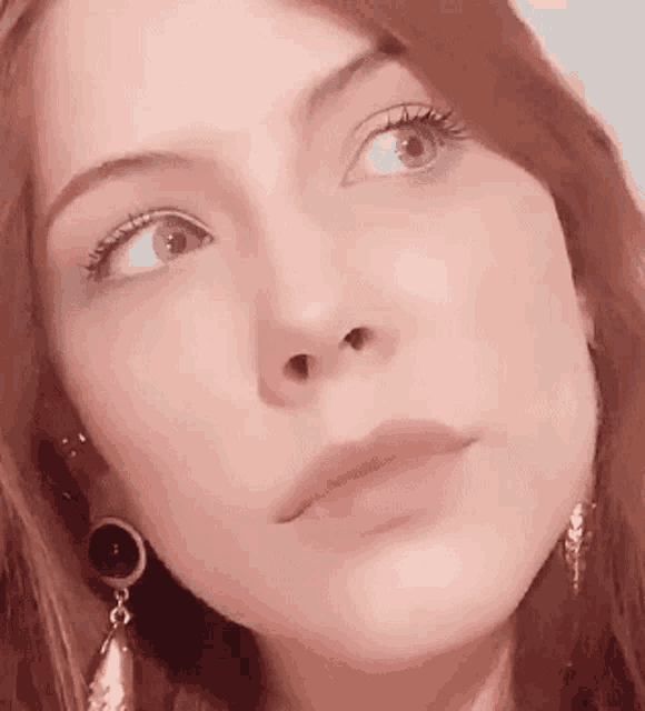 a close up of a woman 's face with her eyes closed