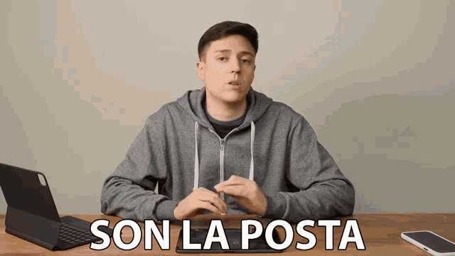 a man sitting at a desk with the words son la posta written on the bottom