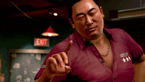 a man in a red shirt is standing in front of a red exit sign