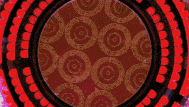 a red and blue heart shaped swirl on a black background