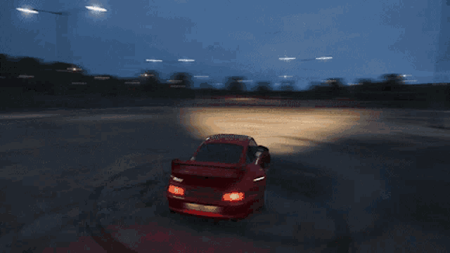 a red car is driving down a dirt road with a sign above it that says rail yard cross country circuit