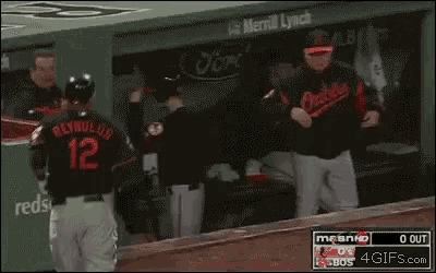a baseball game is being played in a dugout sponsored by ford