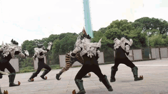 a group of monsters are dancing in a park