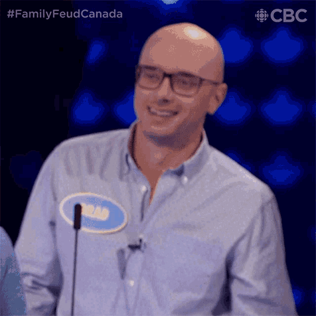 a bald man wearing glasses and a name tag that says brad on it