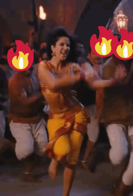 a woman in a yellow skirt is dancing in front of a crowd of people