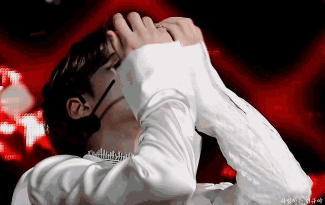 a close up of a person covering their face with their hand
