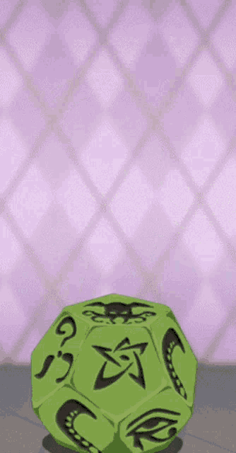 a green dice with symbols on it including a star