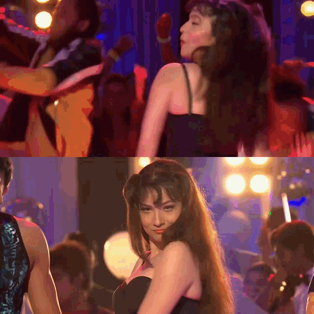 a woman in a black dress is dancing in front of a crowd of people