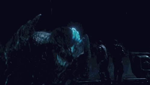 two men are standing in front of a giant monster in the water