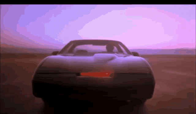 a car with a red light on the back is driving down a road