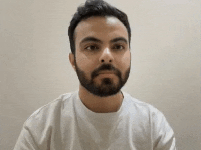 a man with a beard is wearing a white t-shirt