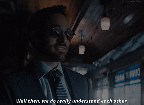 a man in a suit and tie is saying " well then we do really understand each other "