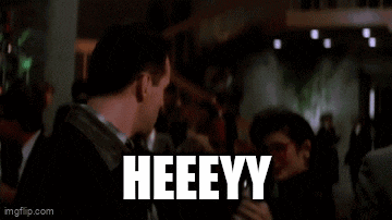 a group of men are standing next to each other and one of them is saying merry christmas to the other .