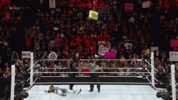 a wrestling ring with a sign that says #raw on the bottom