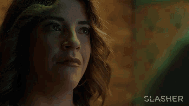 a poster for slasher shows a woman with a serious look on her face