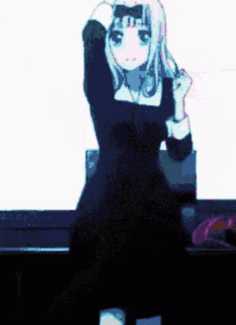 a girl in a black dress is standing in front of a white screen
