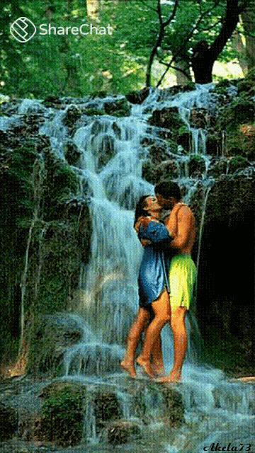 a man and a woman kissing in front of a waterfall with sharechat written on the bottom