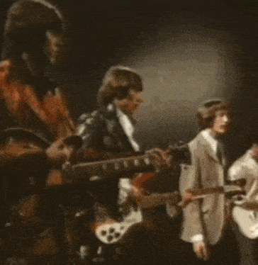 a group of men are playing guitars on stage