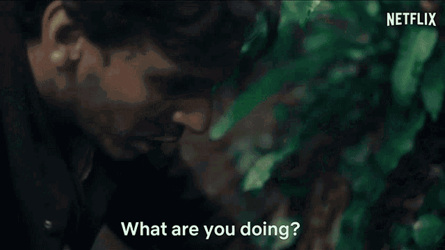 a man holding an axe is asking another man what he 's doing