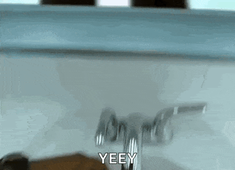 a person is washing their hands in a bathroom sink and they are saying yeey